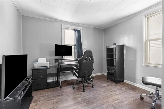 a view of a workspace with furniture and a window