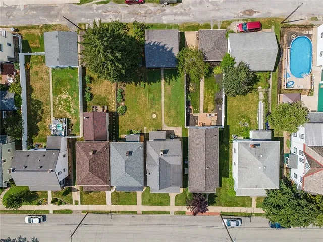 an aerial view of multiple houses with yard