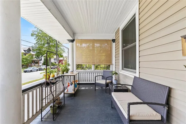 a view of a porch with furniture and a yard