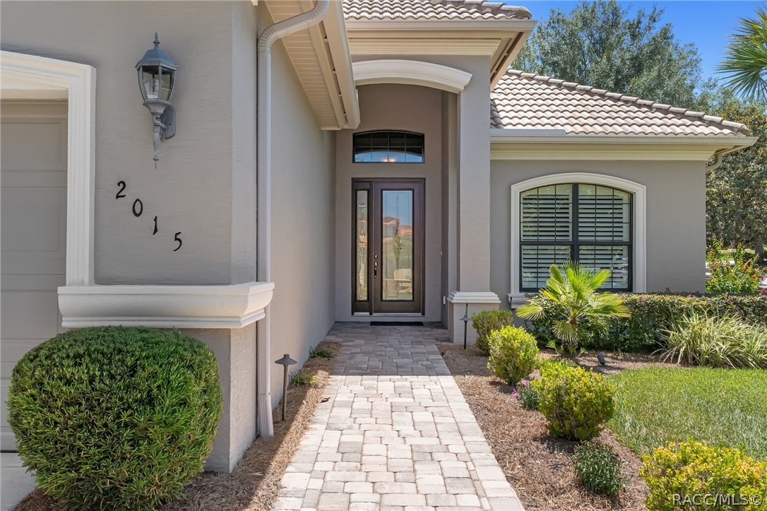 2015 North Rhodes Point Hernando, FL 34442 - Photo 4 of 82 Such a welcoming entry with pavered sidewalk and covered entry.