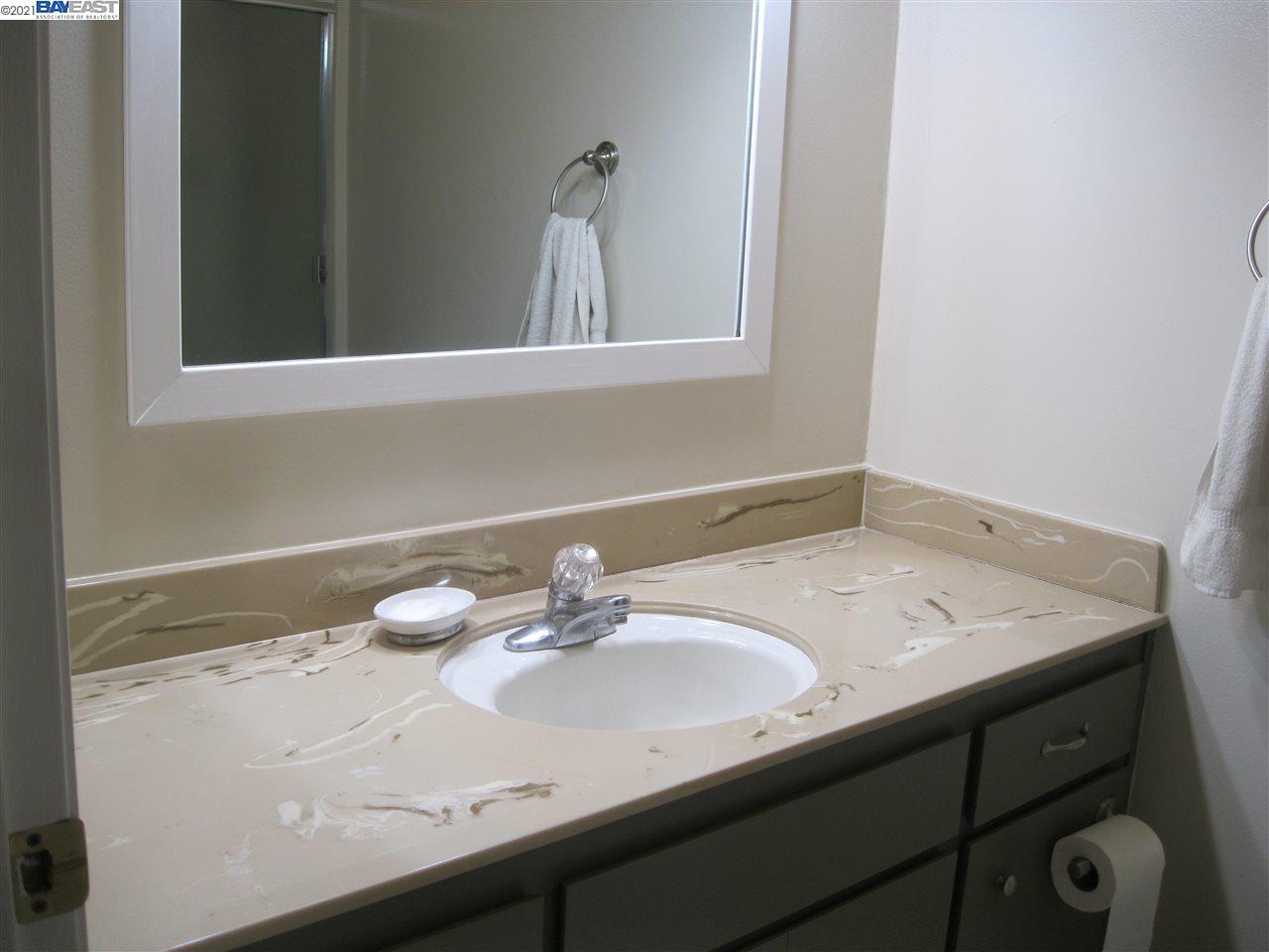 Washington Manor San Leandro, CA 94579 - Photo 13 of 18 a bathroom with a sink and a mirror