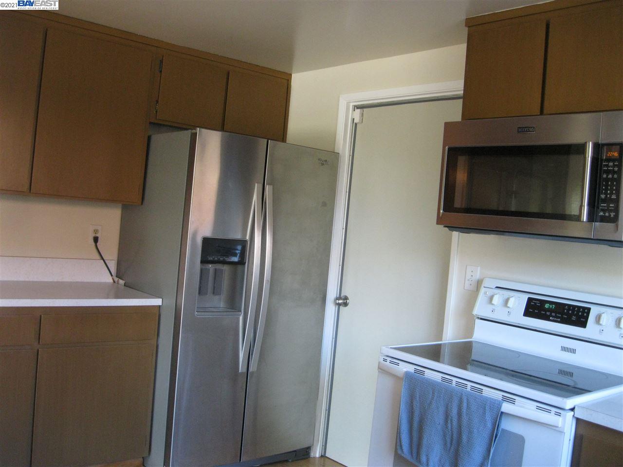 Washington Manor San Leandro, CA 94579 - Photo 8 of 18 a metallic refrigerator freezer sitting in a kitchen