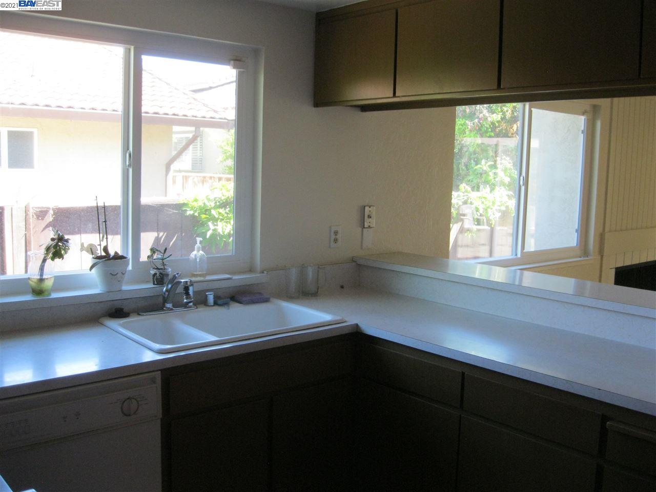 Washington Manor San Leandro, CA 94579 - Photo 9 of 18 a kitchen with a sink a window and cabinets