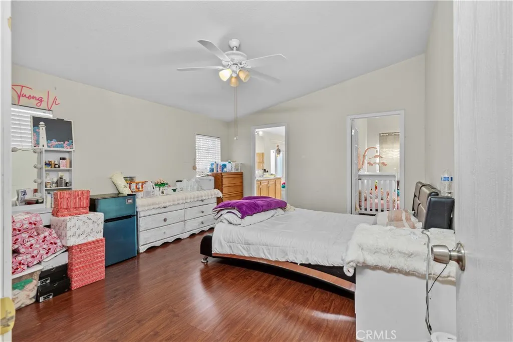 4801 West 1st Street Santa Ana, CA 92703 - Photo 11 of 19 a bedroom with a bed and wooden floor