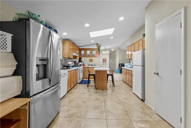 a kitchen with stainless steel appliances a refrigerator and a stove top oven