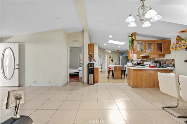 a kitchen with stainless steel appliances kitchen island granite countertop a refrigerator a stove a oven and a sink with granite countertops