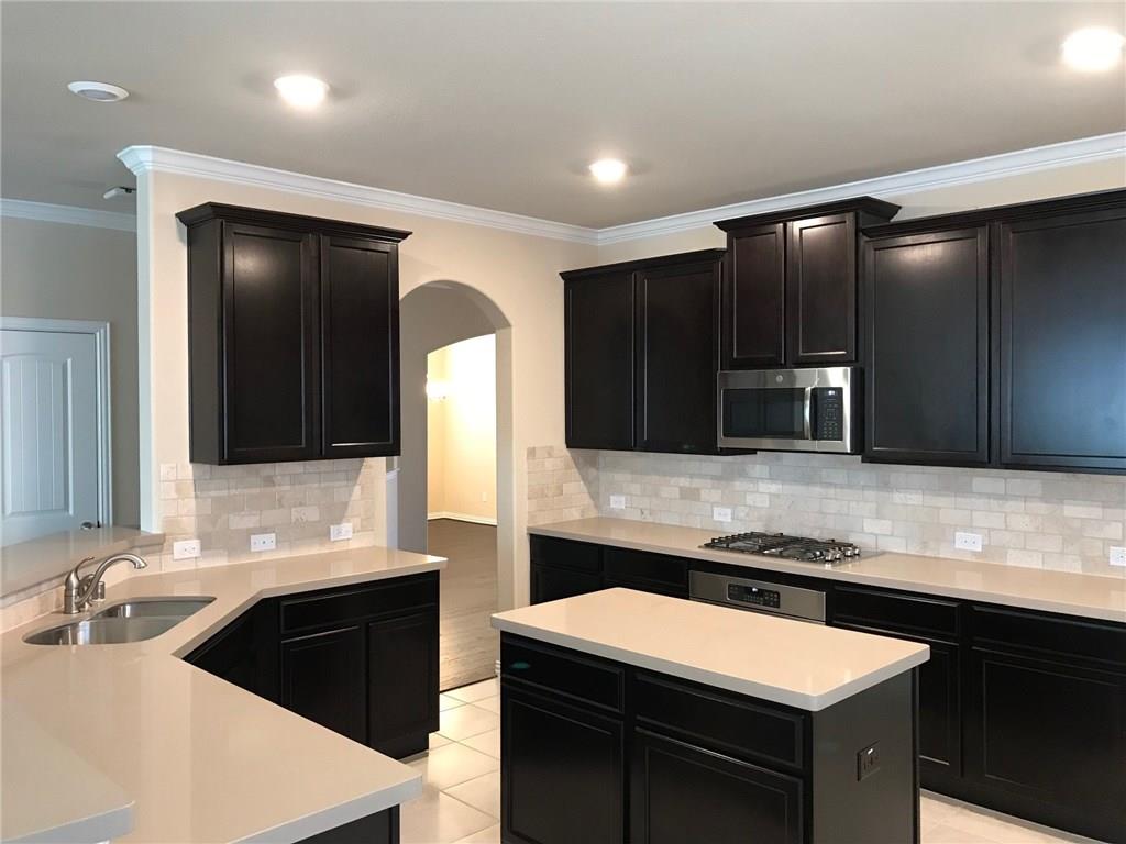 16009 Placid Trail Prosper, TX 75078 - Photo 5 of 18 a large kitchen with a sink and a microwave