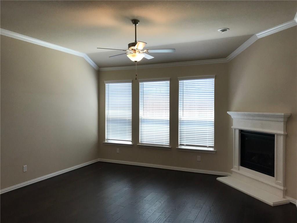 16009 Placid Trail Prosper, TX 75078 - Photo 7 of 18 a view of an empty room with wooden floor fireplace and a window
