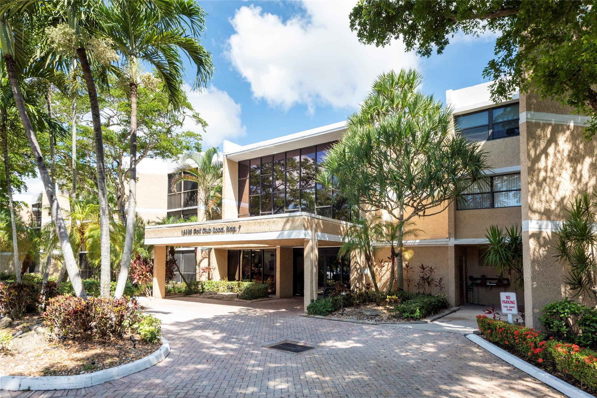 a front view of a building with a garden