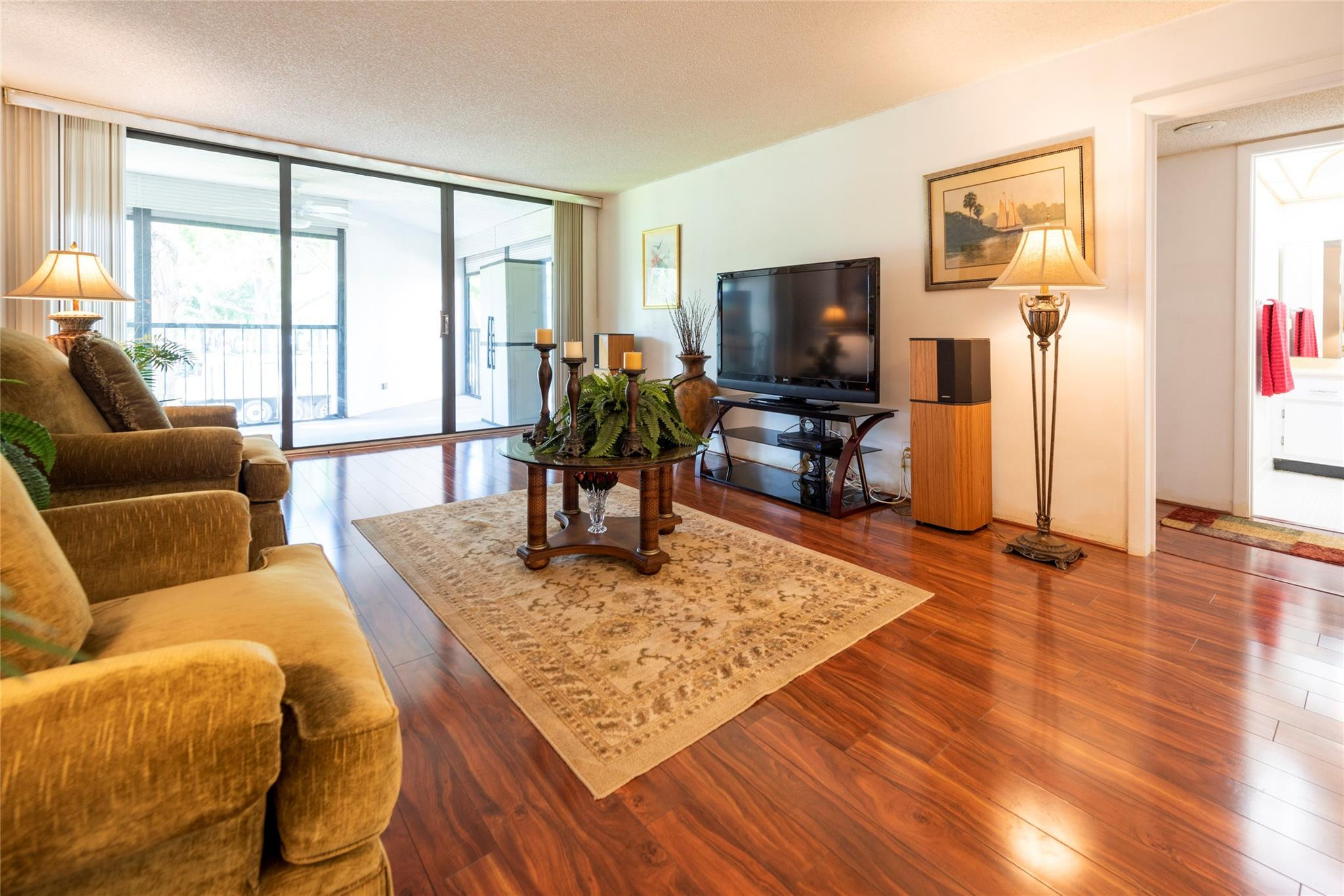 16325 Golf Club Road, Unit 210 Weston, FL 33326 - Photo 3 of 24 a living room with furniture and a flat screen tv