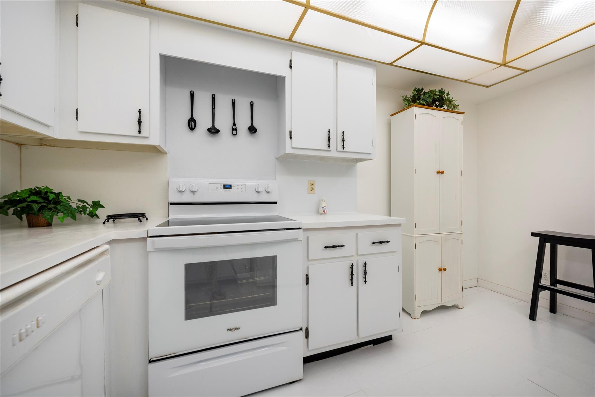 16325 Golf Club Road, Unit 210 Weston, FL 33326 - Photo 7 of 24 a kitchen with white cabinets and white appliances