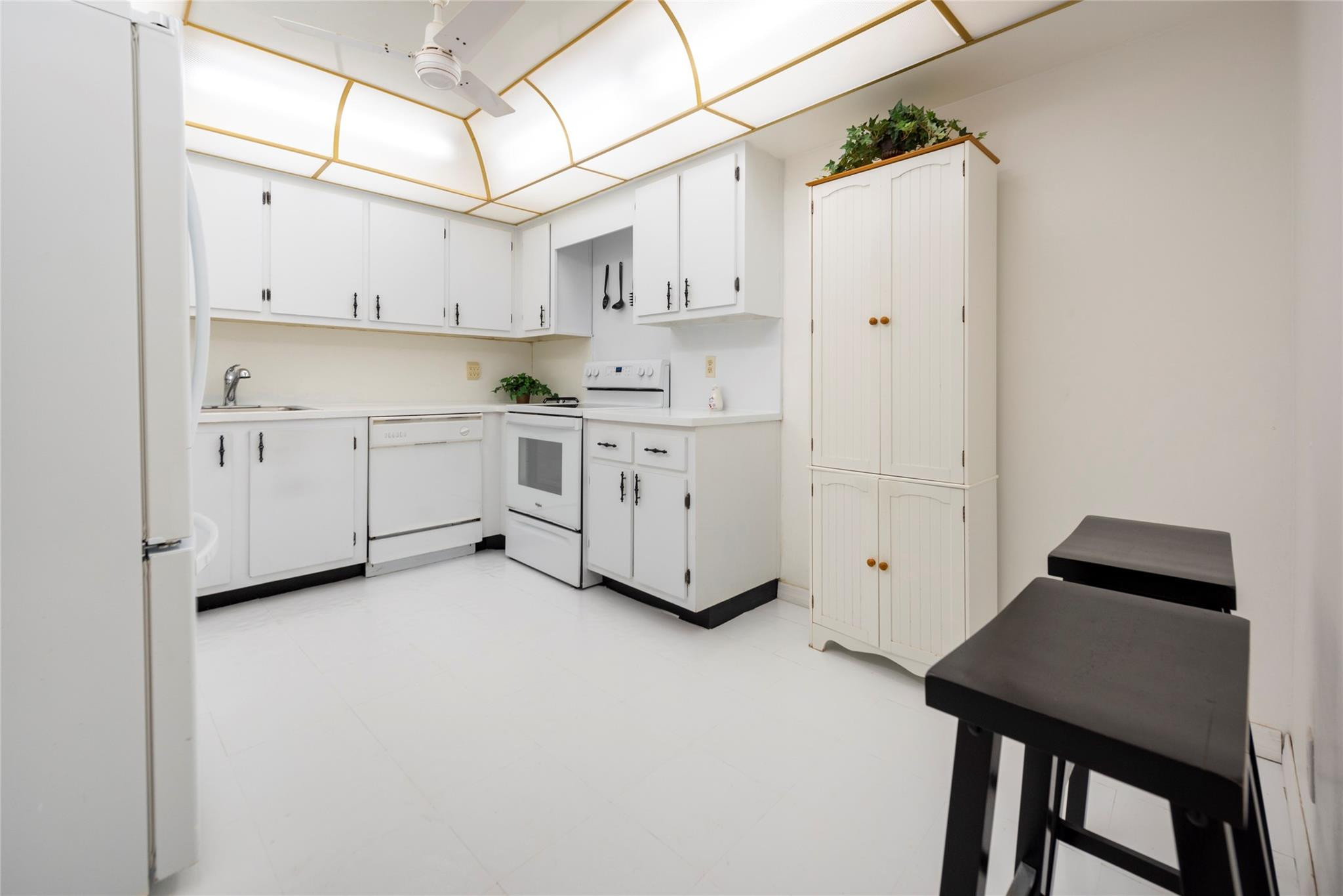 16325 Golf Club Road, Unit 210 Weston, FL 33326 - Photo 8 of 24 a kitchen with white cabinets and white appliances