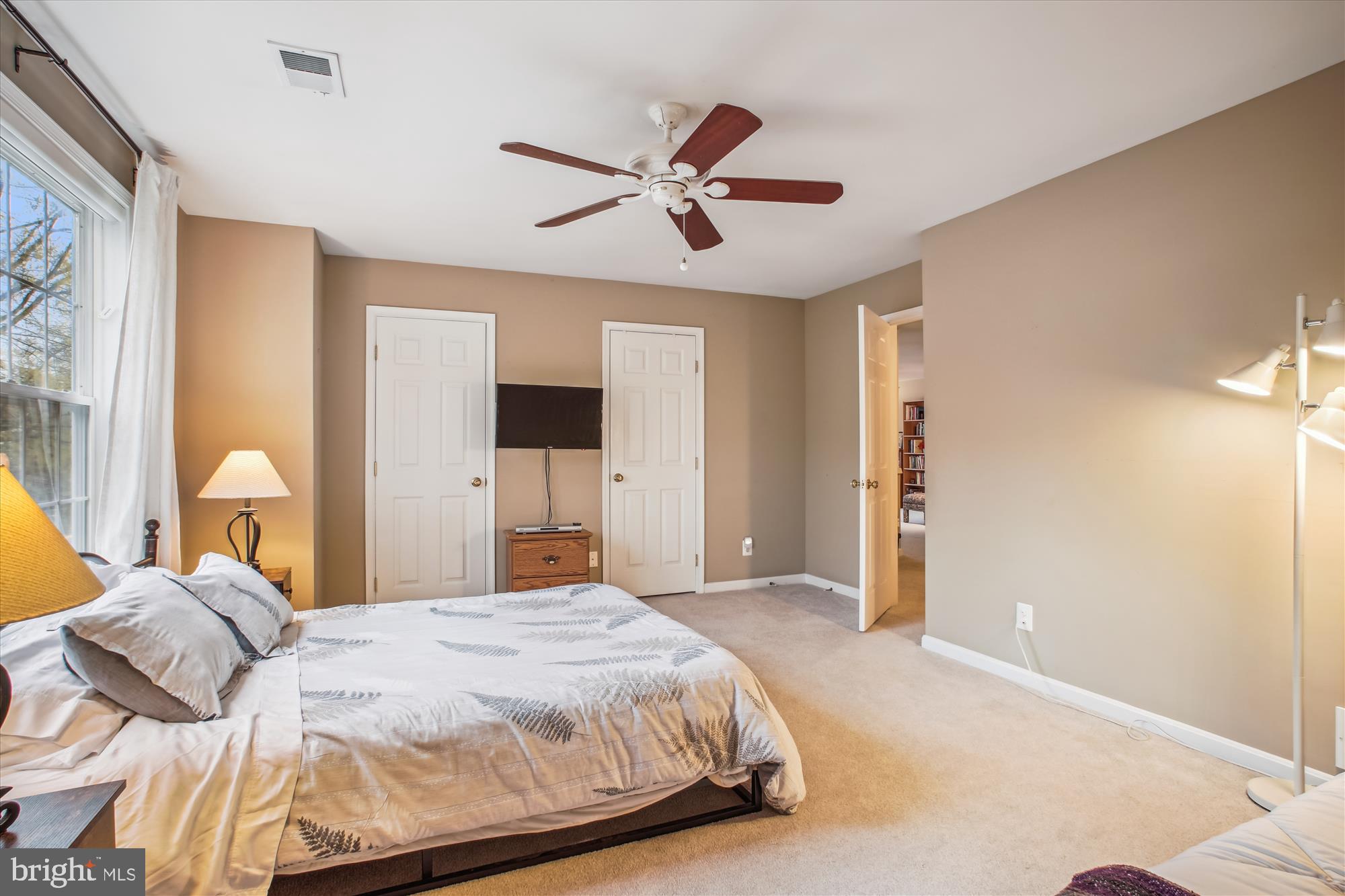 2454 Arctic Fox Way Reston, VA 20191 - Photo 28 of 54 a bedroom with a large bed and a chandelier