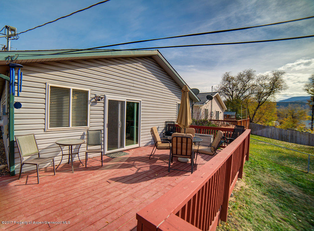 815 Whiteriver Avenue Rifle, CO 81650 - Photo 3 of 15 a balcony with table and chairs and wooden floor