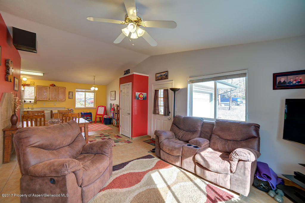 815 Whiteriver Avenue Rifle, CO 81650 - Photo 8 of 15 a living room with furniture a flat screen tv and a window