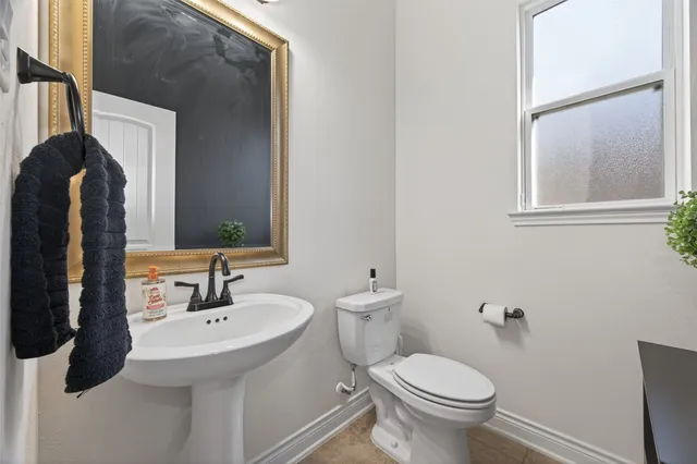 a bedroom with a bed couch and window