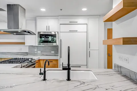 a kitchen with kitchen island a counter top space appliances and cabinets