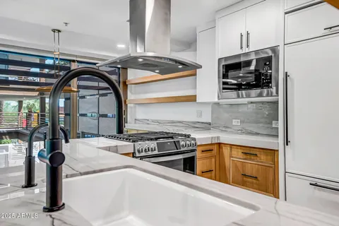 a kitchen with stainless steel appliances granite countertop a stove and a sink