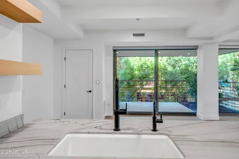 a view of empty room with wooden floor and floor to ceiling window