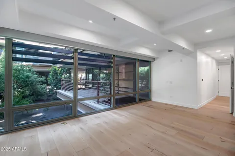 a view of empty room with wooden floor