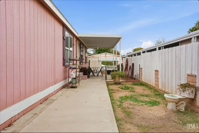 a view of a patio with table and chairs
