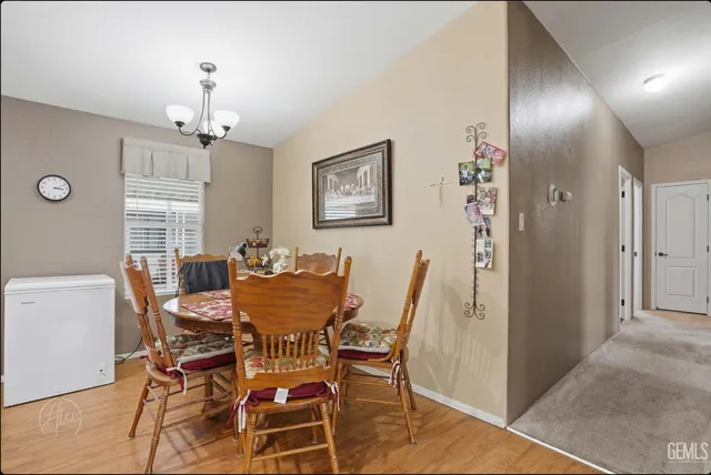 a view of a dining room with furniture and a chandelier
