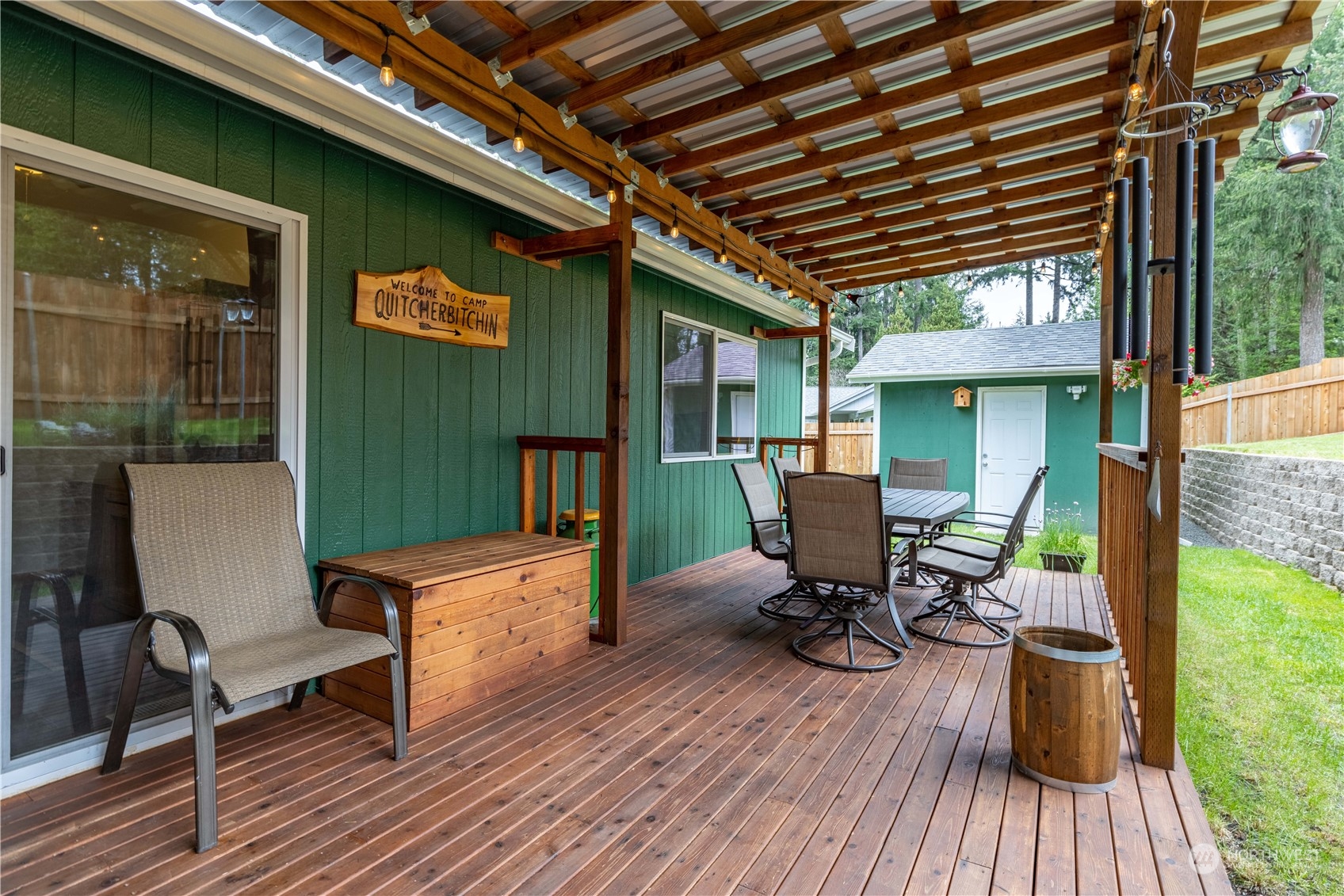 80 East Dunvegan Road Shelton, WA 98584 - Photo 16 of 24 a view of a deck with table and chairs with wooden floor and fence