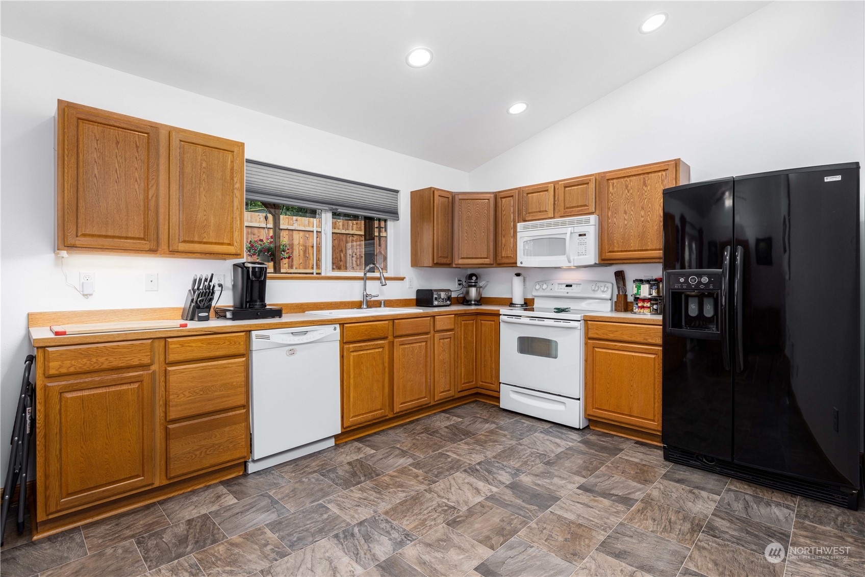 80 East Dunvegan Road Shelton, WA 98584 - Photo 5 of 24 a kitchen with white cabinets and refrigerator