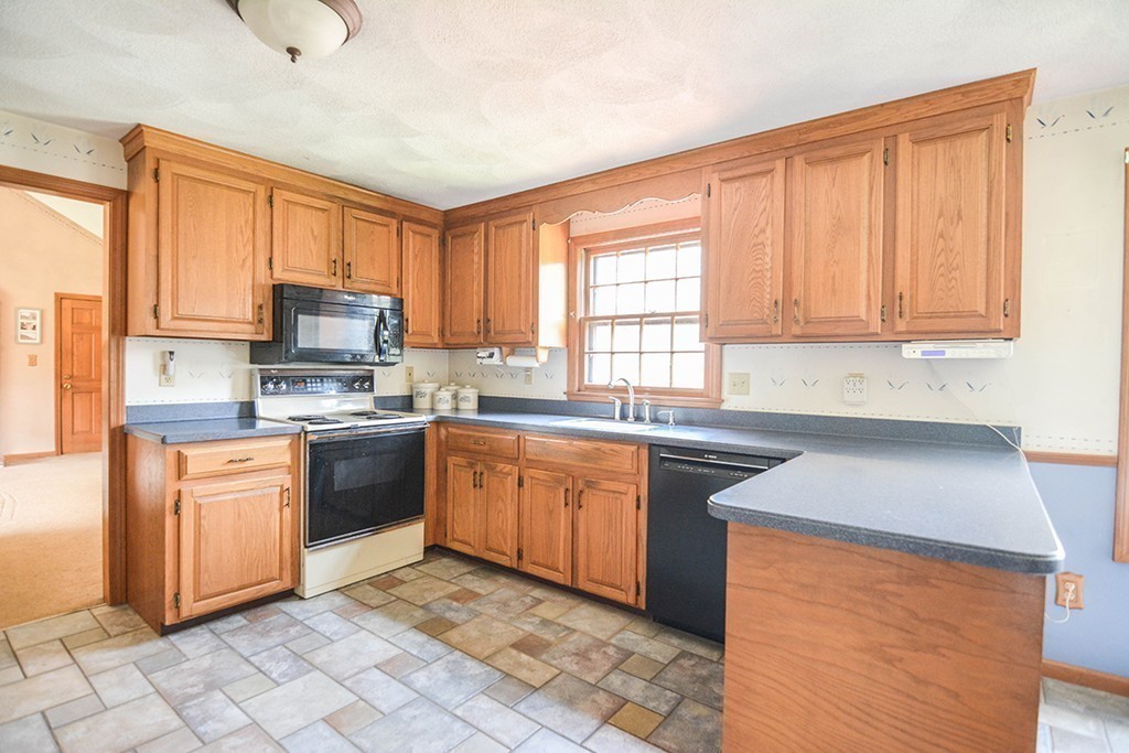 26 Old Homestead Road Groton, MA 01450 - Photo 3 of 19 a kitchen with stainless steel appliances granite countertop a refrigerator sink and cabinets
