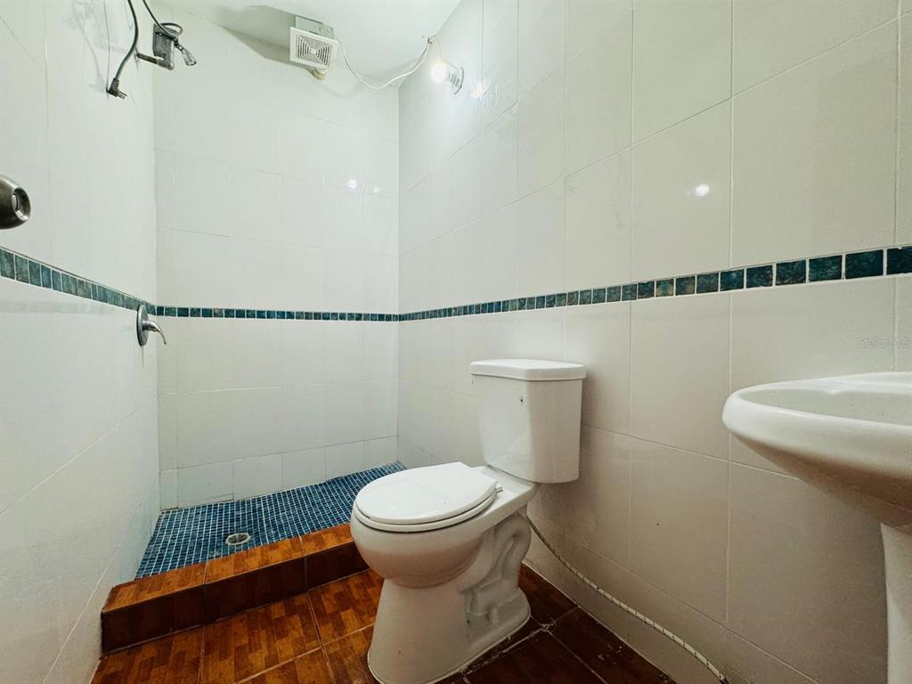 908 Bo Tejas, Unit 7 Humacao, PR 00791 - Photo 5 of 7 a bathroom with a toilet and a shower