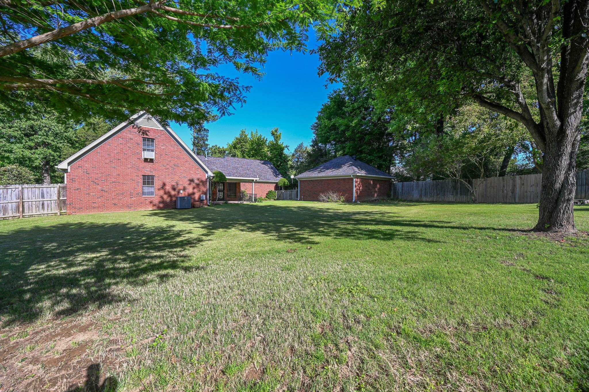 3746 Broadway Road Bartlett, TN 38135 - Photo 36 of 39 Expansive green lawn with mature trees providing natural shade.