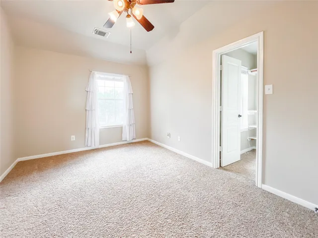 an empty room with a empty space and a ceiling fan
