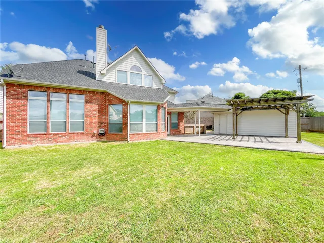 an aerial view of residential house with outdoor space and swimming pool