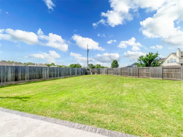 an aerial view of a swimming pool with outdoor seating