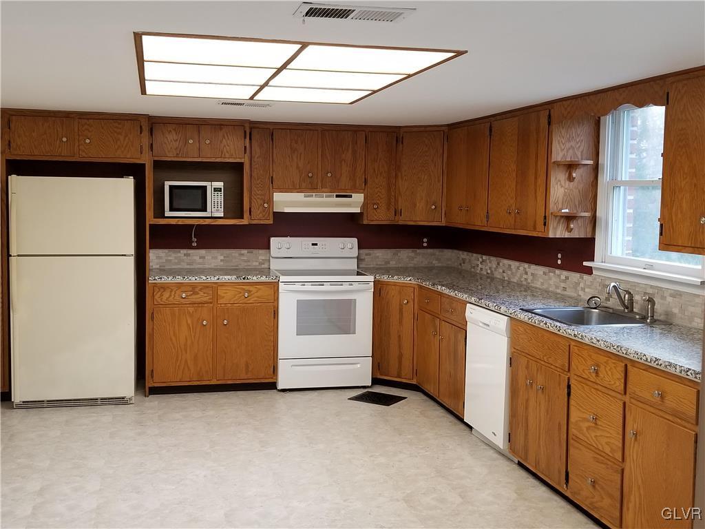 28 Millrace Road Northampton, PA 18067 - Photo 2 of 5 a kitchen with sink a stove and cabinets