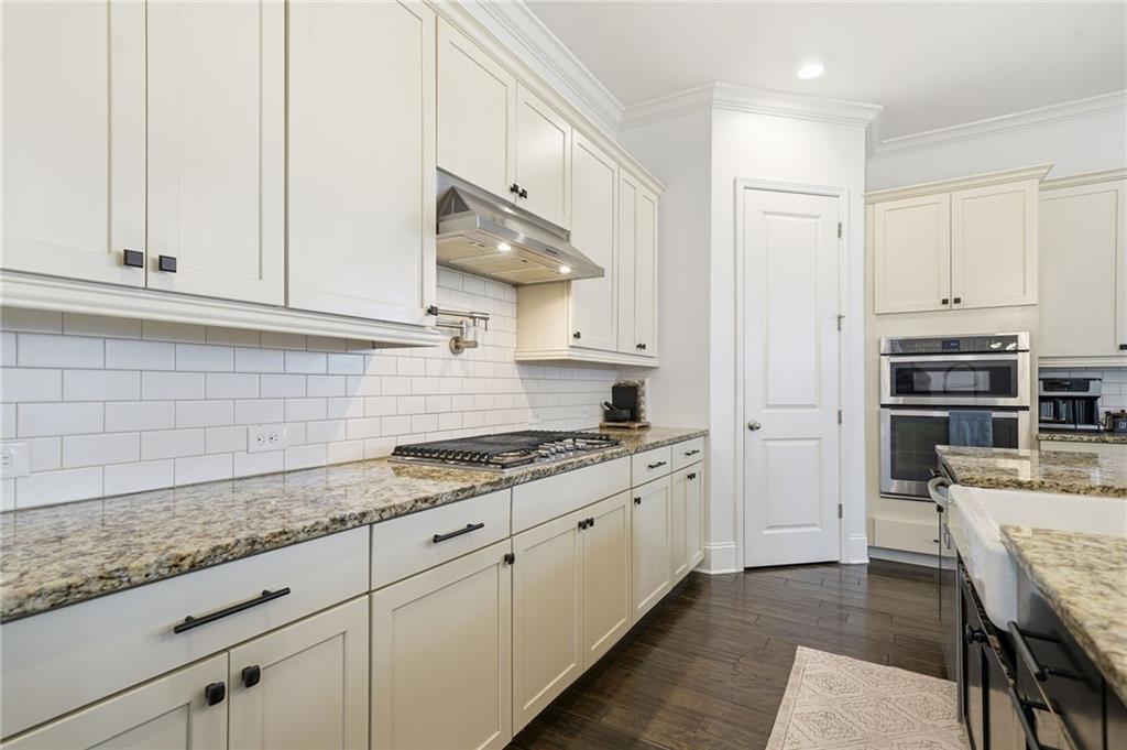 178 Fieldbrook Crossing Canton, GA 30115 - Photo 18 of 71 a kitchen with granite countertop white cabinets and stainless steel appliances