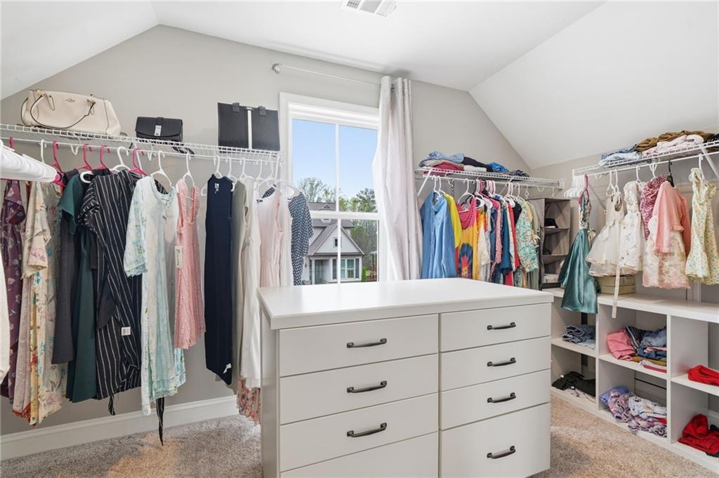 178 Fieldbrook Crossing Canton, GA 30115 - Photo 29 of 71 a view of walk in closet with clothes and shoes
