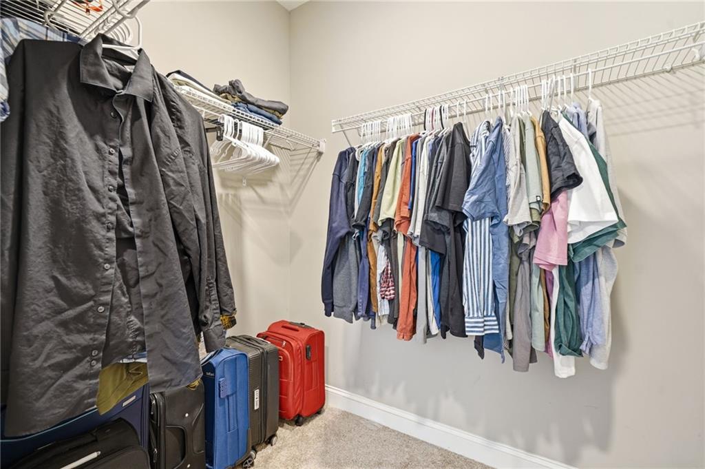 178 Fieldbrook Crossing Canton, GA 30115 - Photo 31 of 71 a view of walk in closet with clothes and shoes