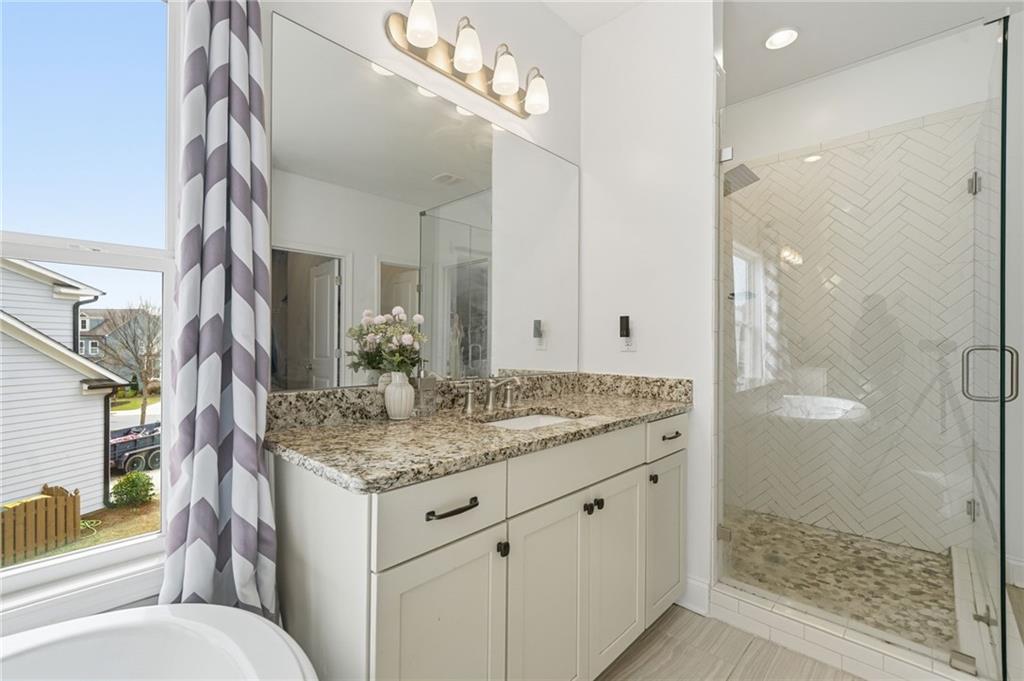 178 Fieldbrook Crossing Canton, GA 30115 - Photo 34 of 71 a bathroom with a granite countertop sink and a mirror