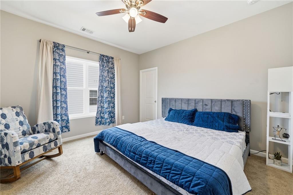 178 Fieldbrook Crossing Canton, GA 30115 - Photo 42 of 71 a bedroom with a bed and a chandelier