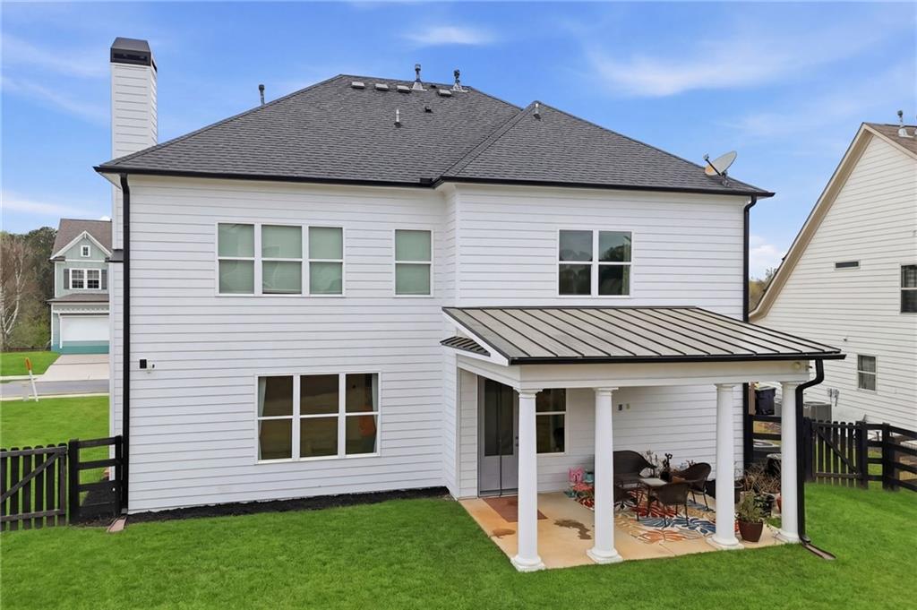178 Fieldbrook Crossing Canton, GA 30115 - Photo 49 of 71 a view of a house with a yard and lawn chairs with a yard