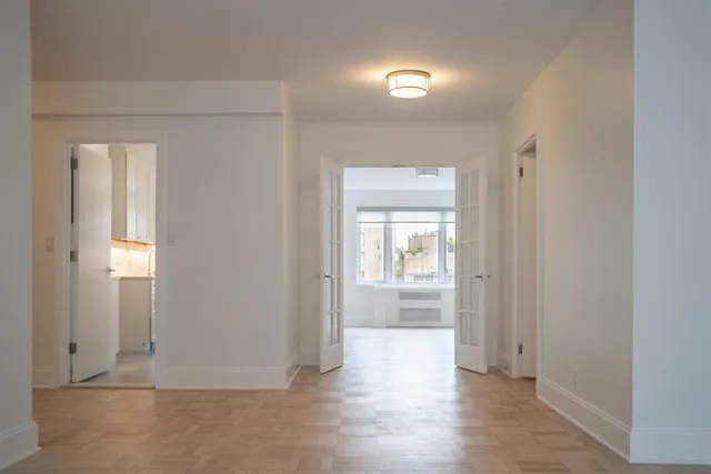 a kitchen with granite countertop a sink stove and cabinets