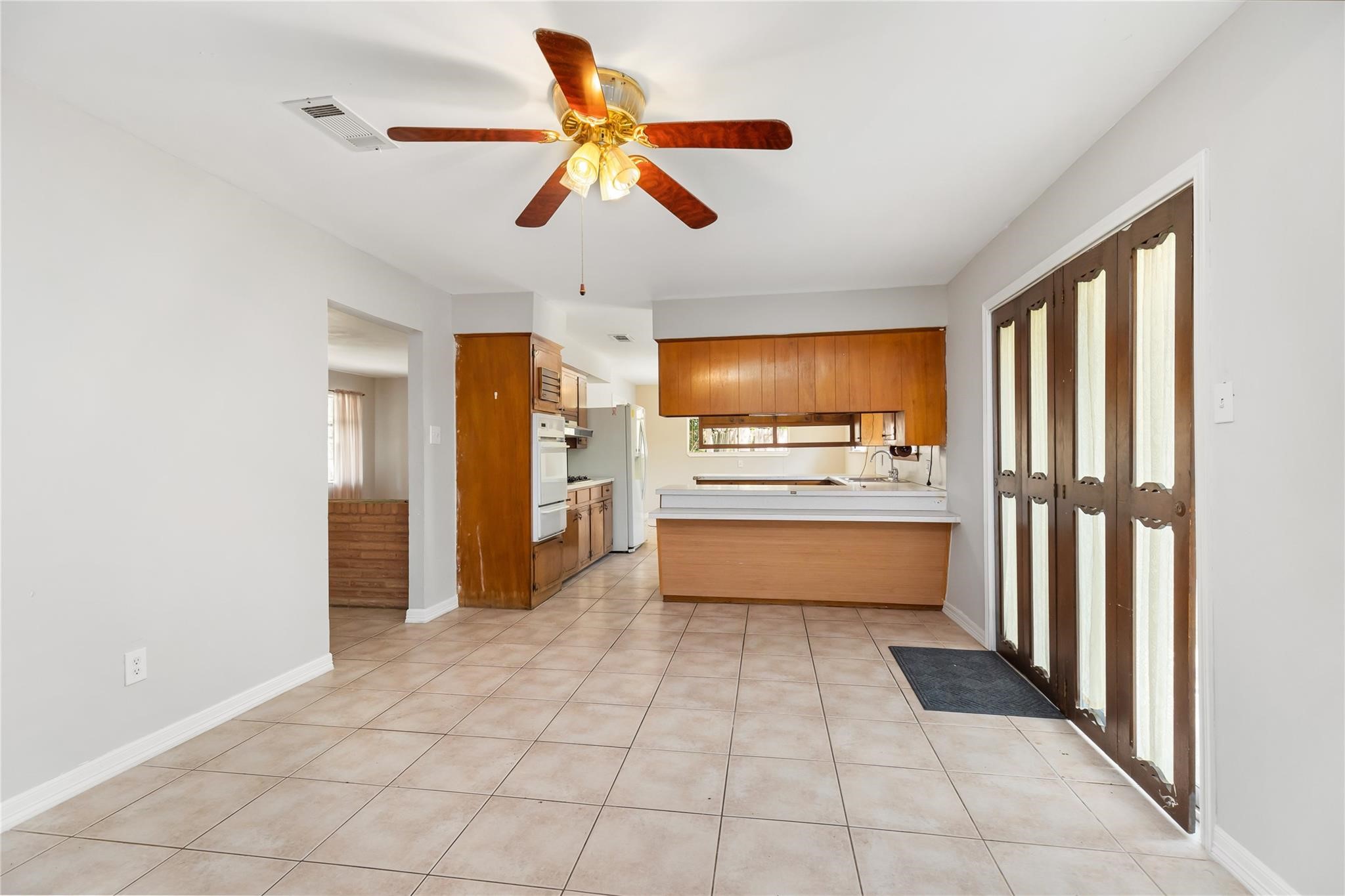 29518 West Hawthorne Drive Spring, TX 77386 - Photo 11 of 22 a kitchen with stainless steel appliances kitchen island granite countertop a refrigerator and a sink