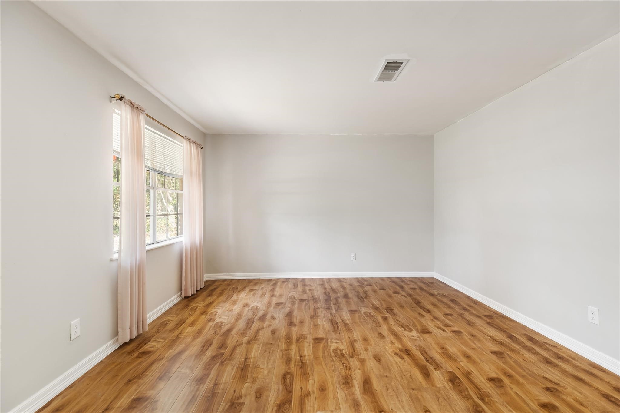 29518 West Hawthorne Drive Spring, TX 77386 - Photo 2 of 22 a view of a room with wooden floor and white walls