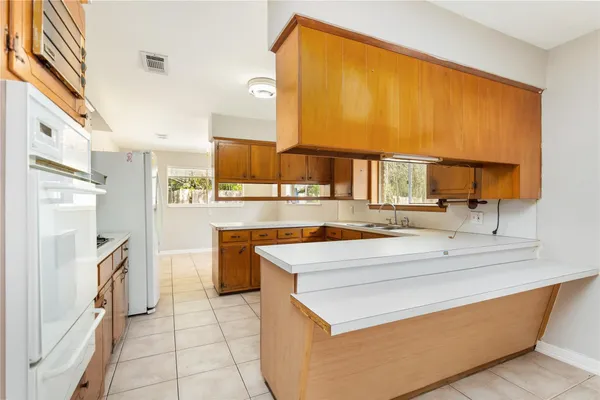 a kitchen with stainless steel appliances granite countertop a sink and a stove