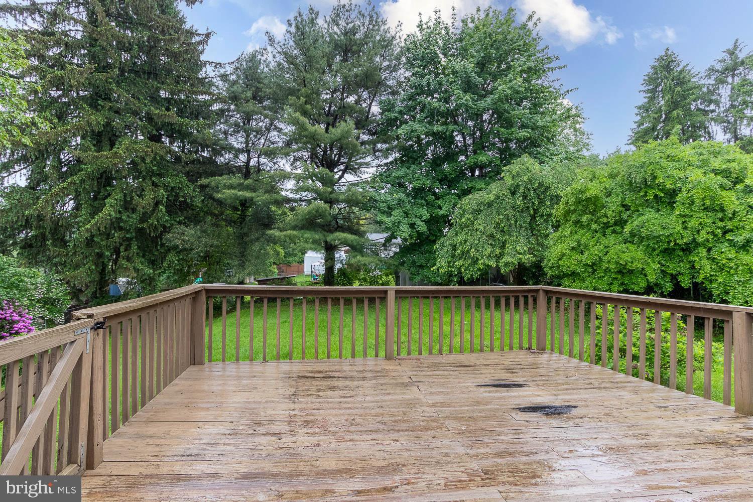 1724 East Branch Road State College, PA 16801 - Photo 29 of 31 Spacious deck surrounded by lush greenery.