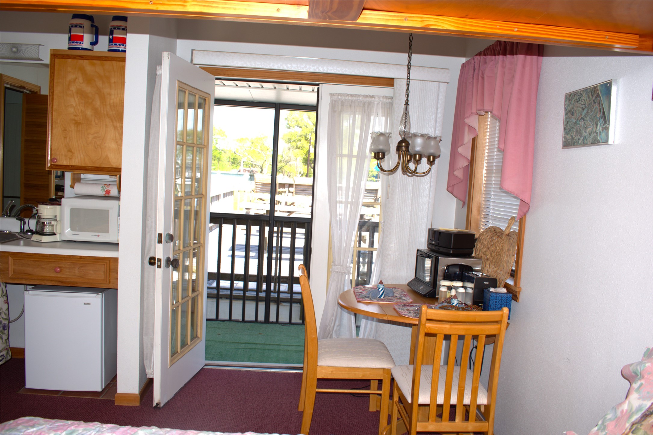 1657 County Road Sargent, TX 77414 - Photo 26 of 46 Upstairs separate 2nd bedroom for that teenager or extended family with kitchenette, screened porch, access to a huge sundeck over the boat house. Great place to gather and party as well!