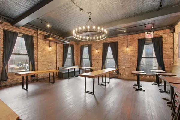 a view of a room with lots of furniture and windows