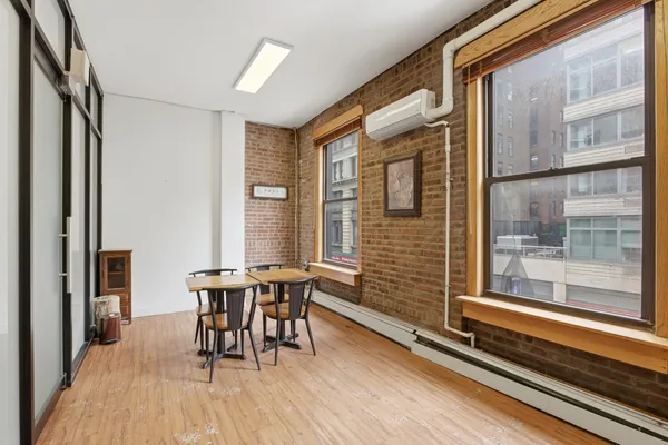 a dining room with furniture and wooden floor