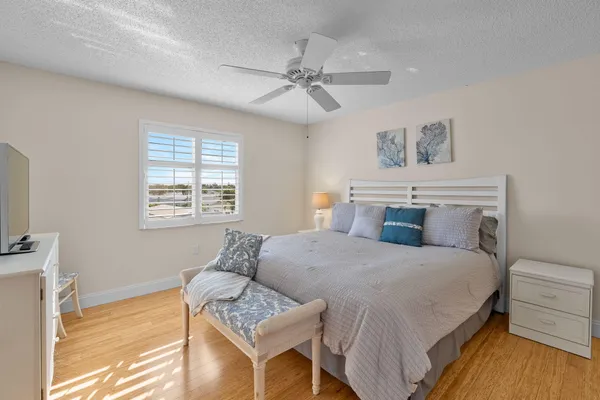 a bedroom with a bed and a painting on the wall